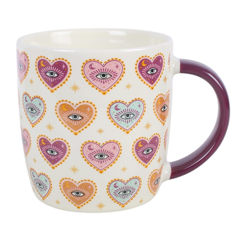 Tasse mit Herz-Augen-Motiv und Teesieb mit Herzanhänger