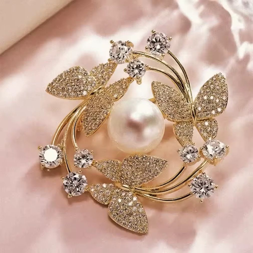 Schmetterlings-Brosche Gold mit Perle und Zirkonia auf rosa Satin